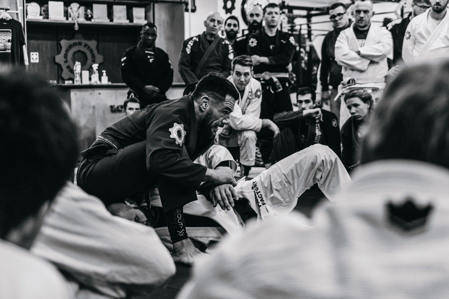 An instructor demonstrating a position while the room watches