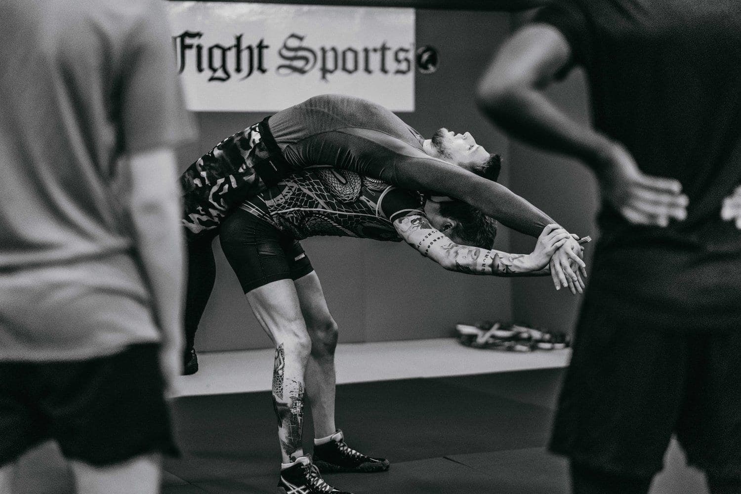 A wrestler carrying his partner across his back