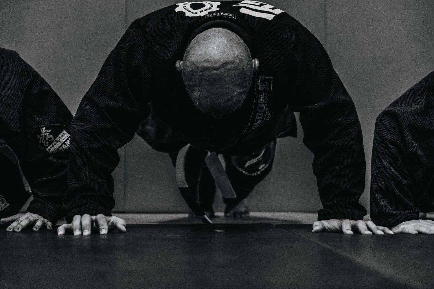A line of grapplers holding a push-up position