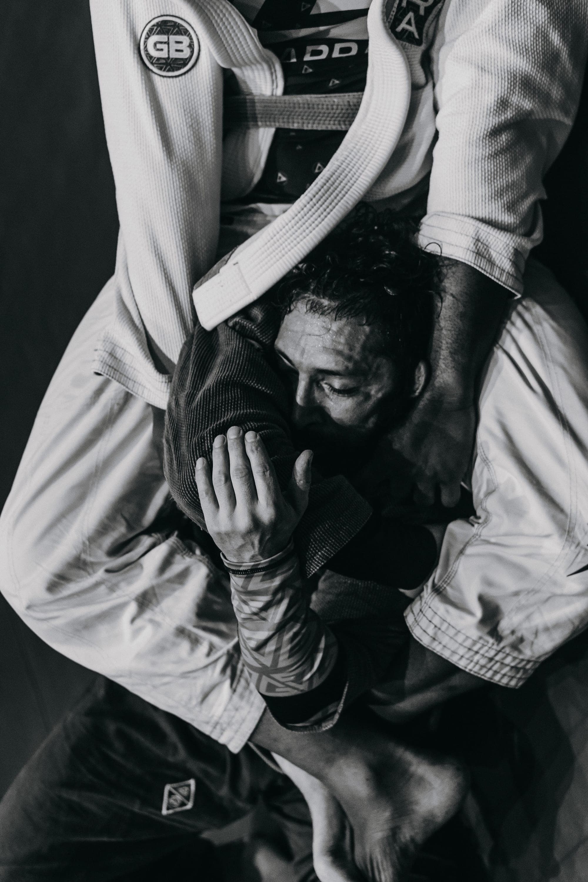 A grappler caught in a submission, shot from above